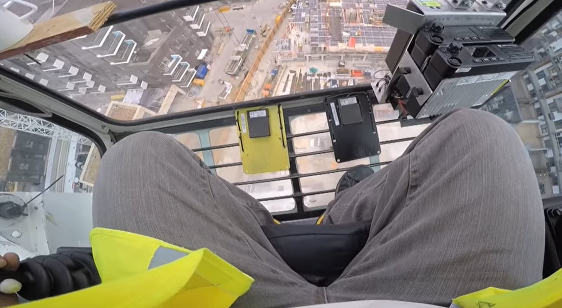 The crane operator uses two mobile two way radios